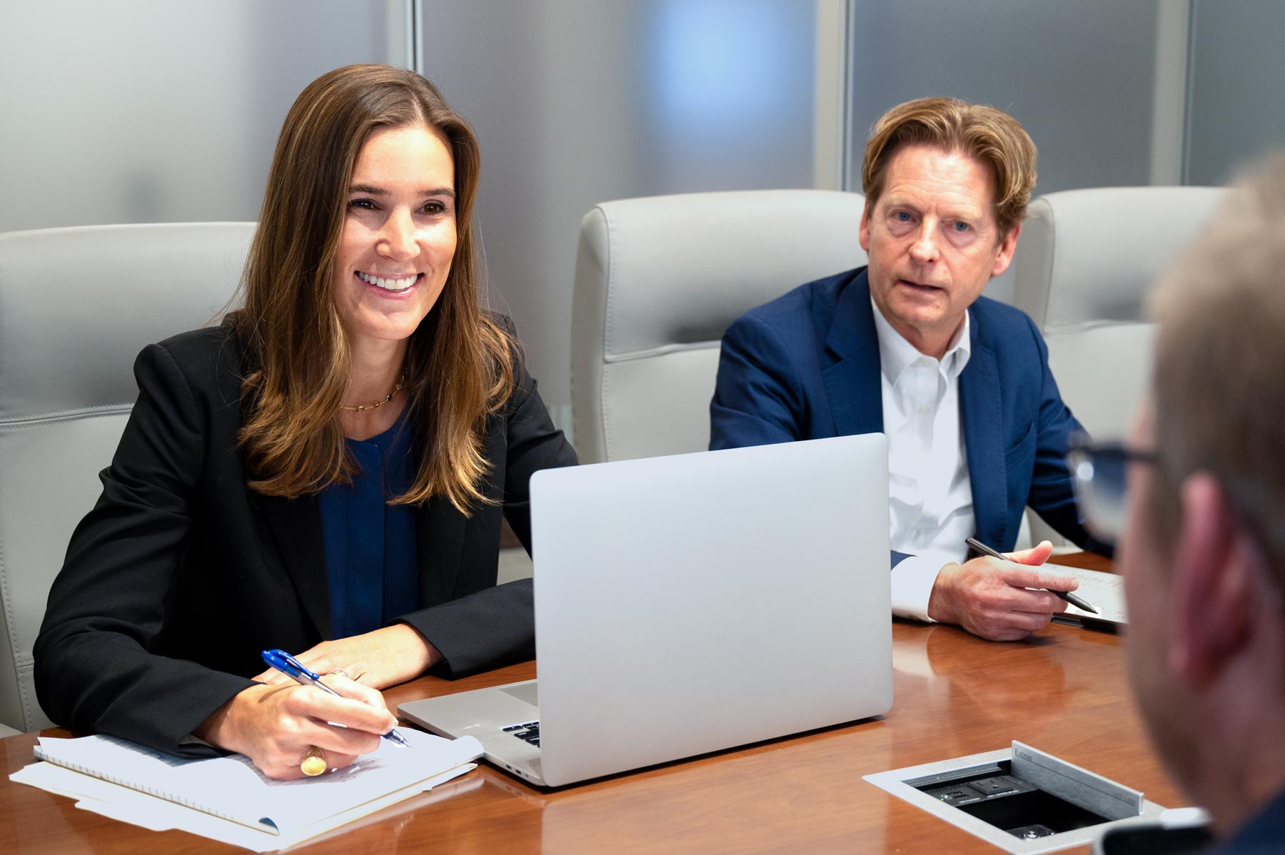 Two Dinsmore team members sitting in a meeting helping a client.