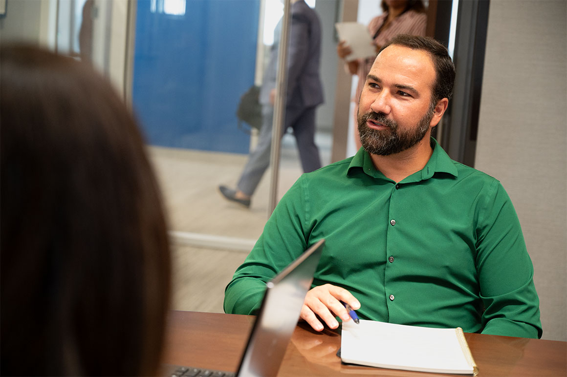 man in green at desk