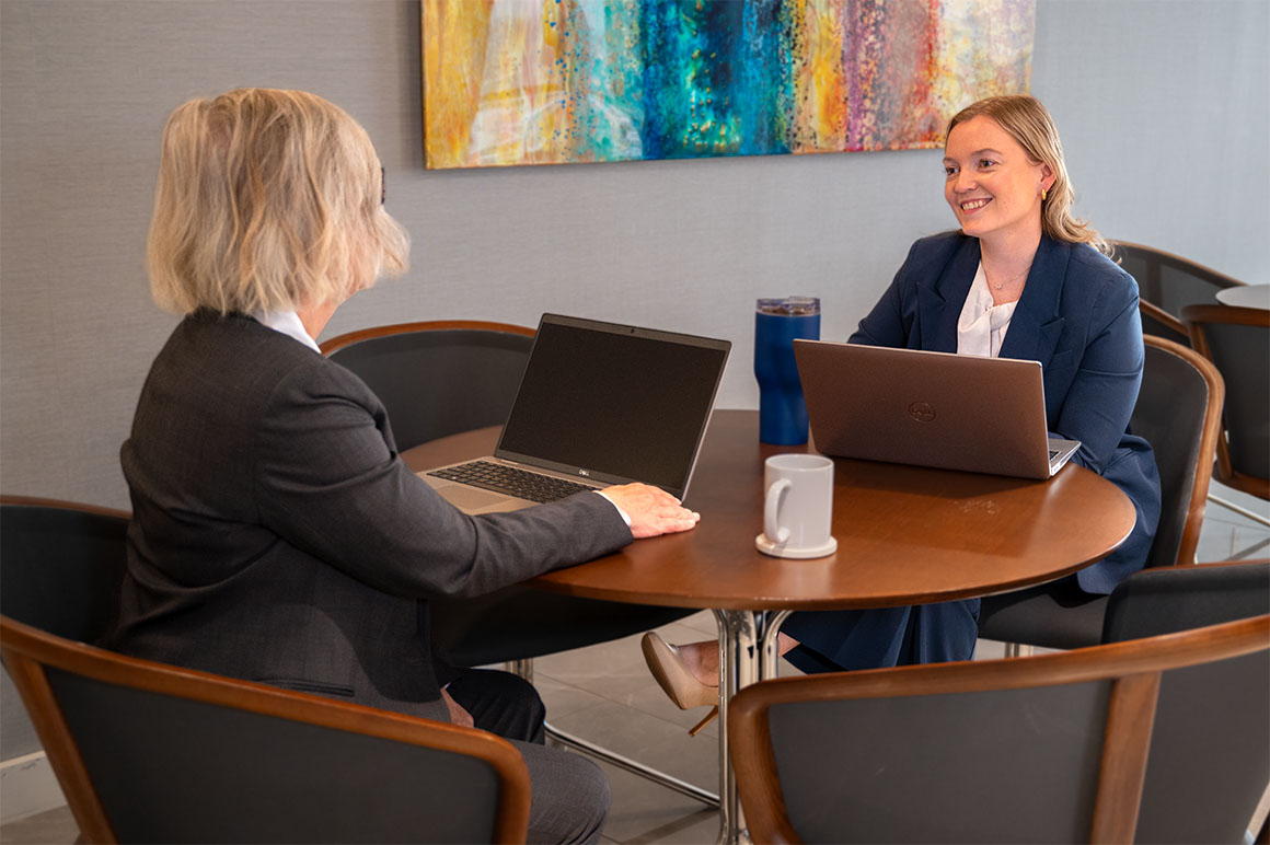 woman at desk with laptops